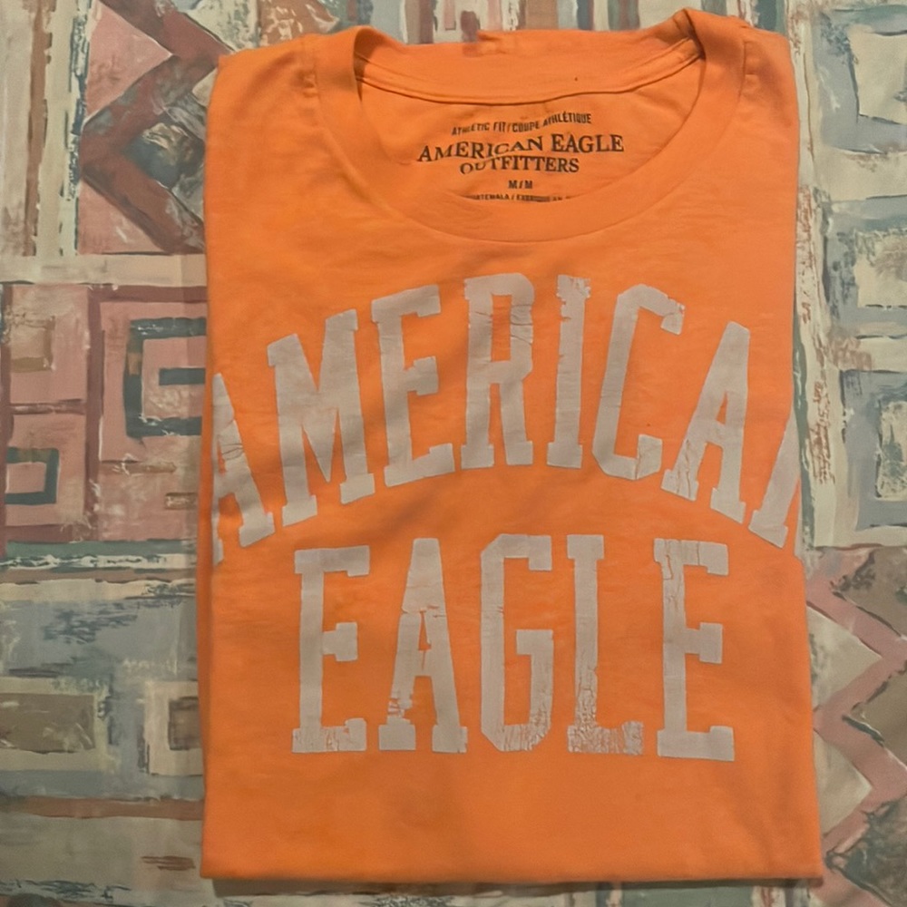 A medium orange American eagle t-shirt fair condition